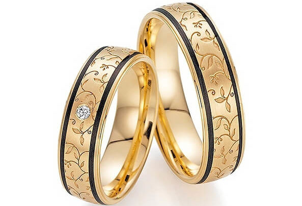 Golden rings with black stripes and floral pattern