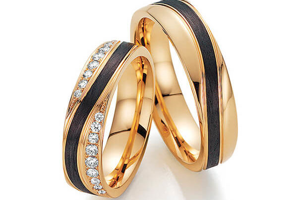 Golden wedding rings with a black stripe