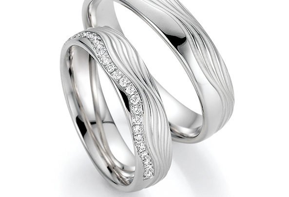 Silver wedding rings with wave pattern