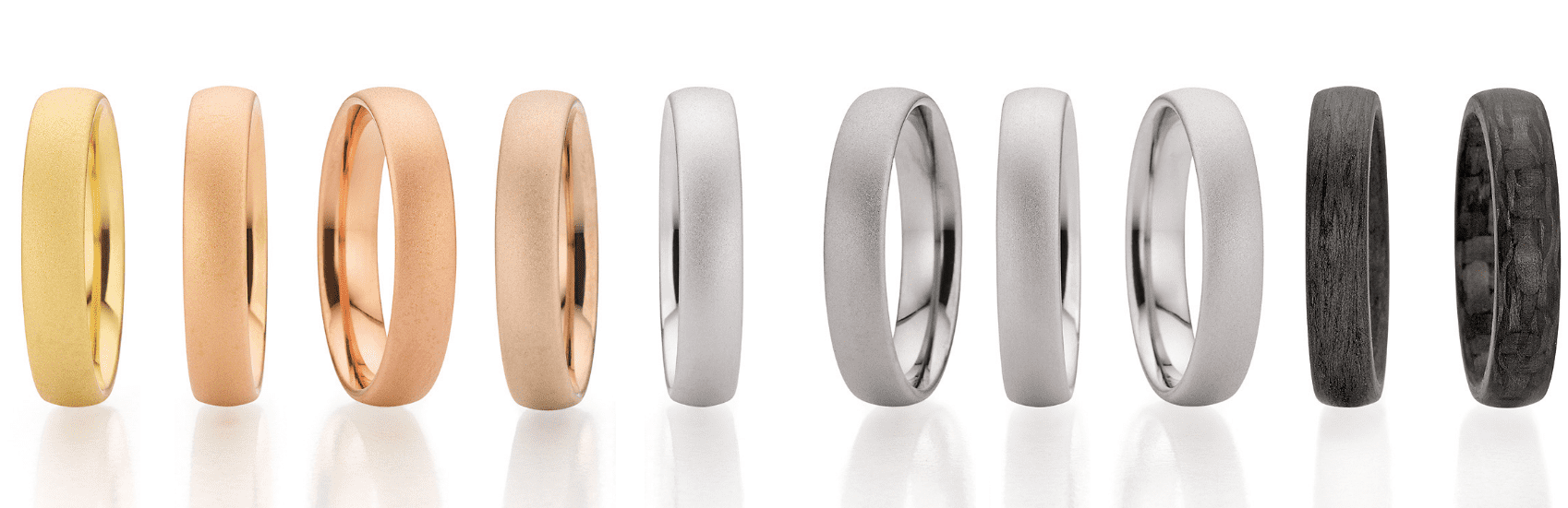 Wedding rings in different alloys and colors. From left to right: a ring made of yellow gold, apricot gold, red gold, caramel gold, white gold, gray gold, platinum, palladium and two darker rings made of carbon.